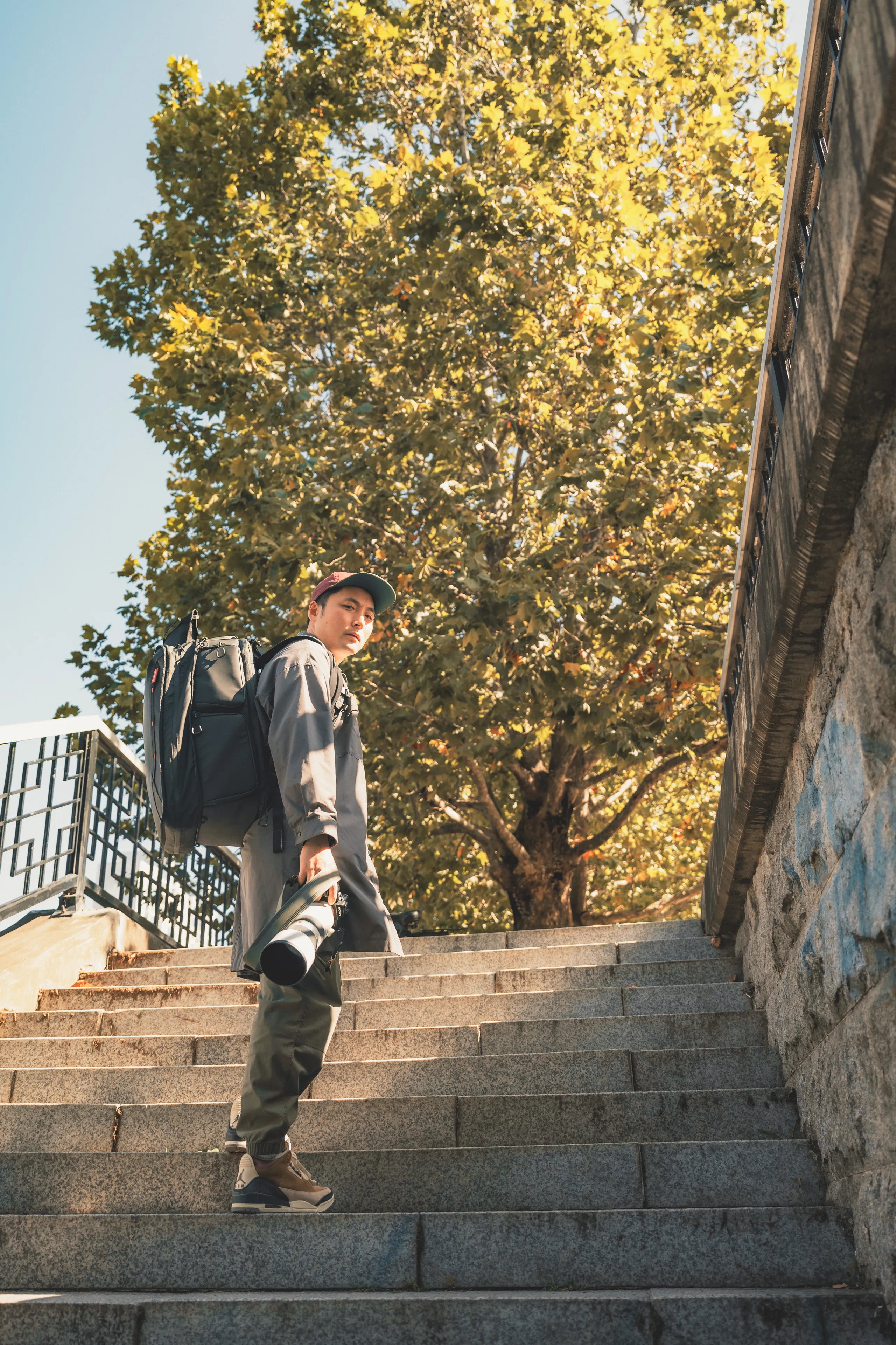Tak on location in Seoul, camera and telephoto lens in hand
