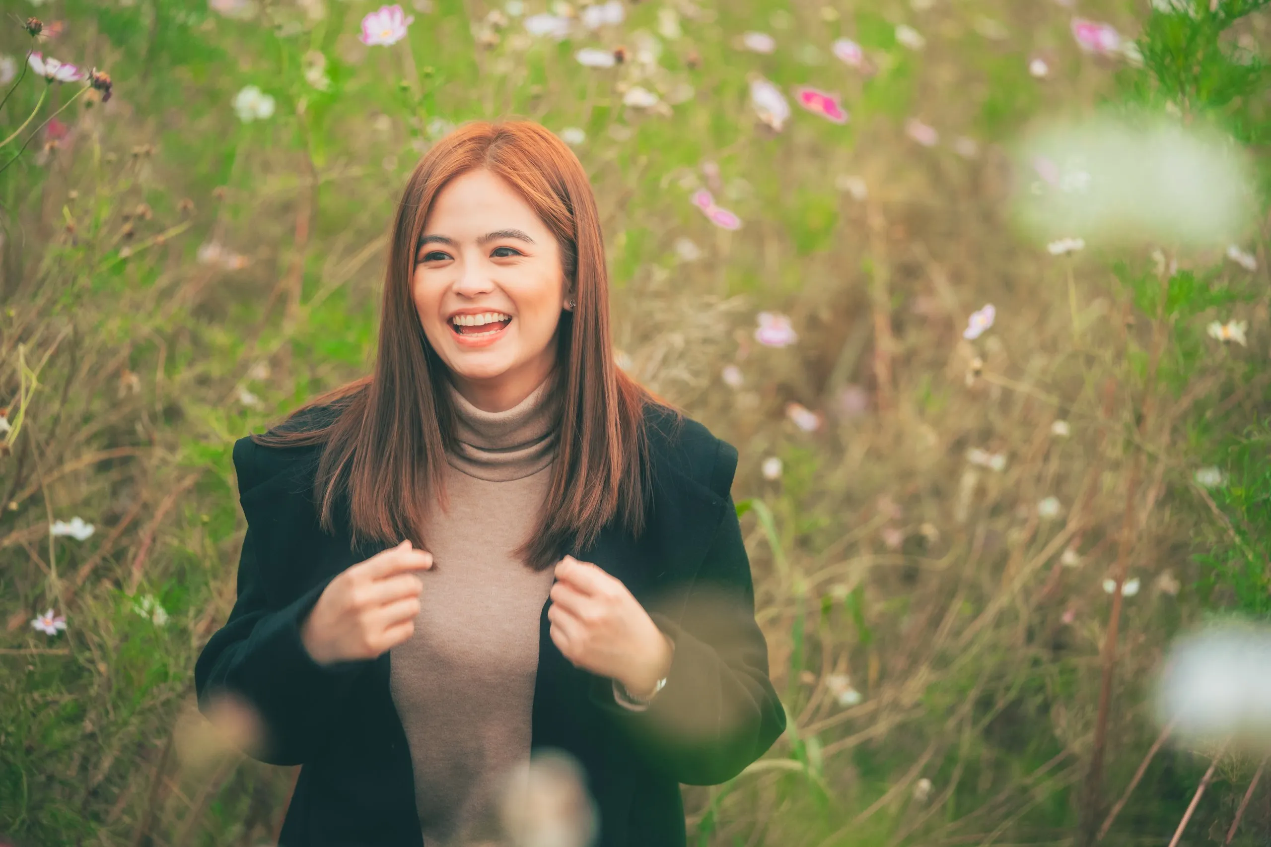 Bea Binene smiling in a cosmos field