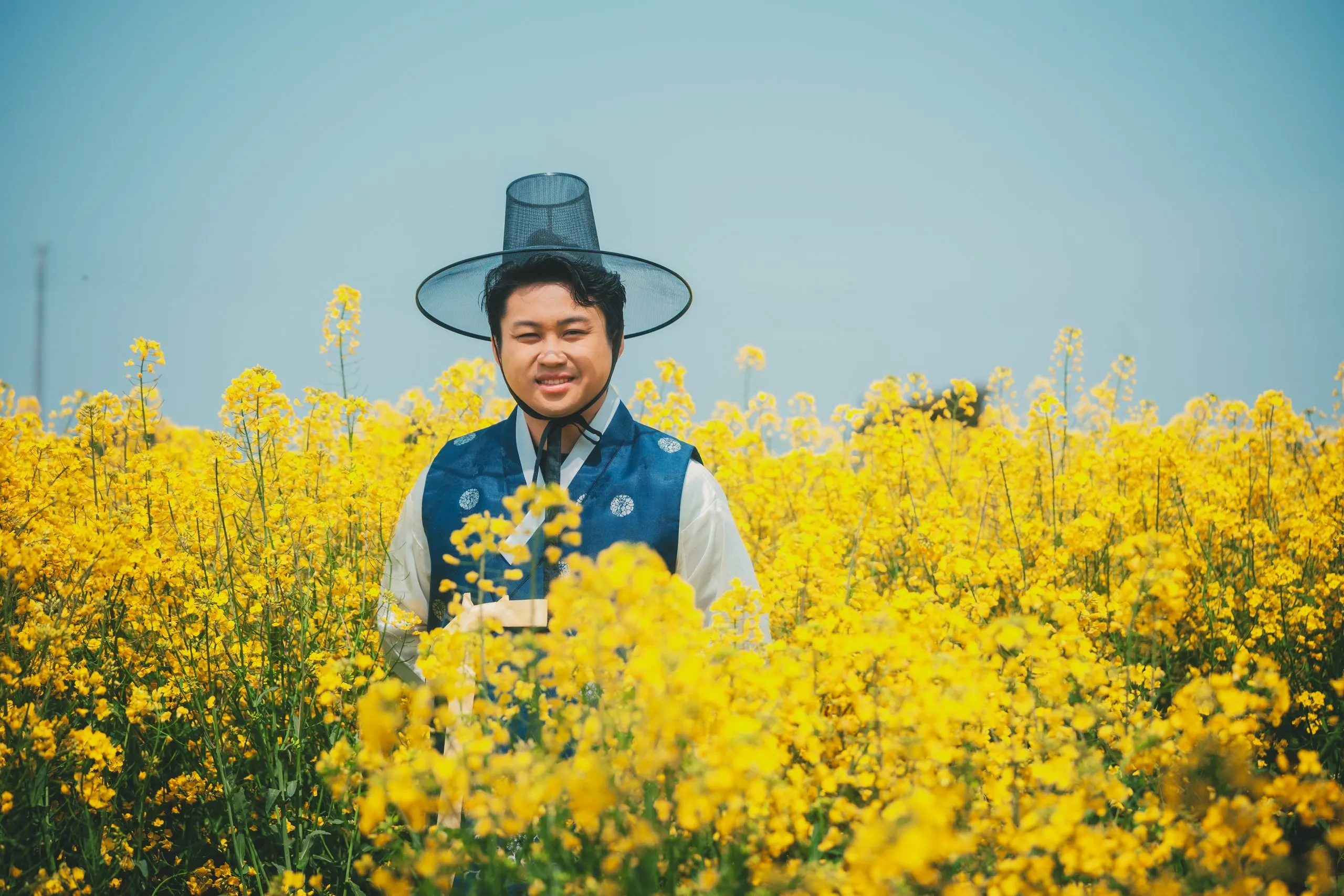 Ivan and Mindy in the canola field under Sanbangsan