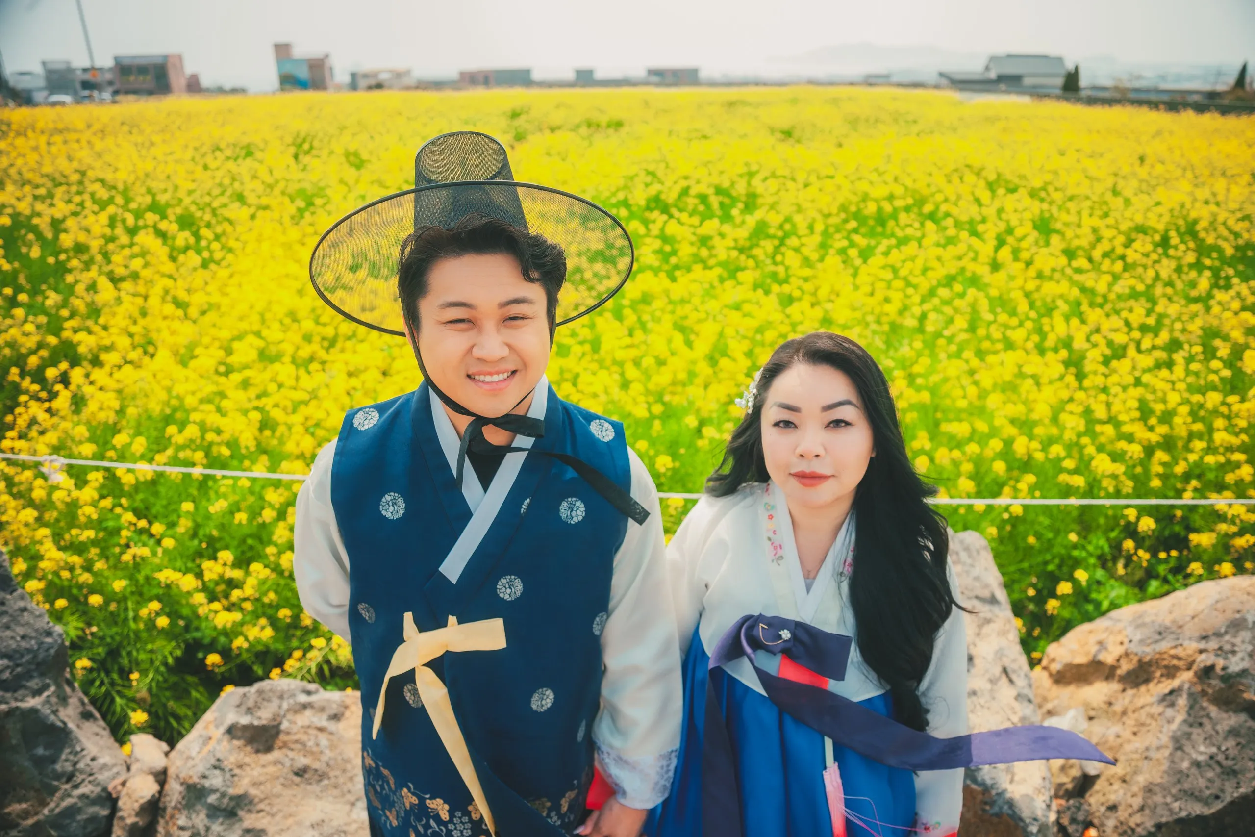 Ivan and Mindy in a canola field on Jeju Island