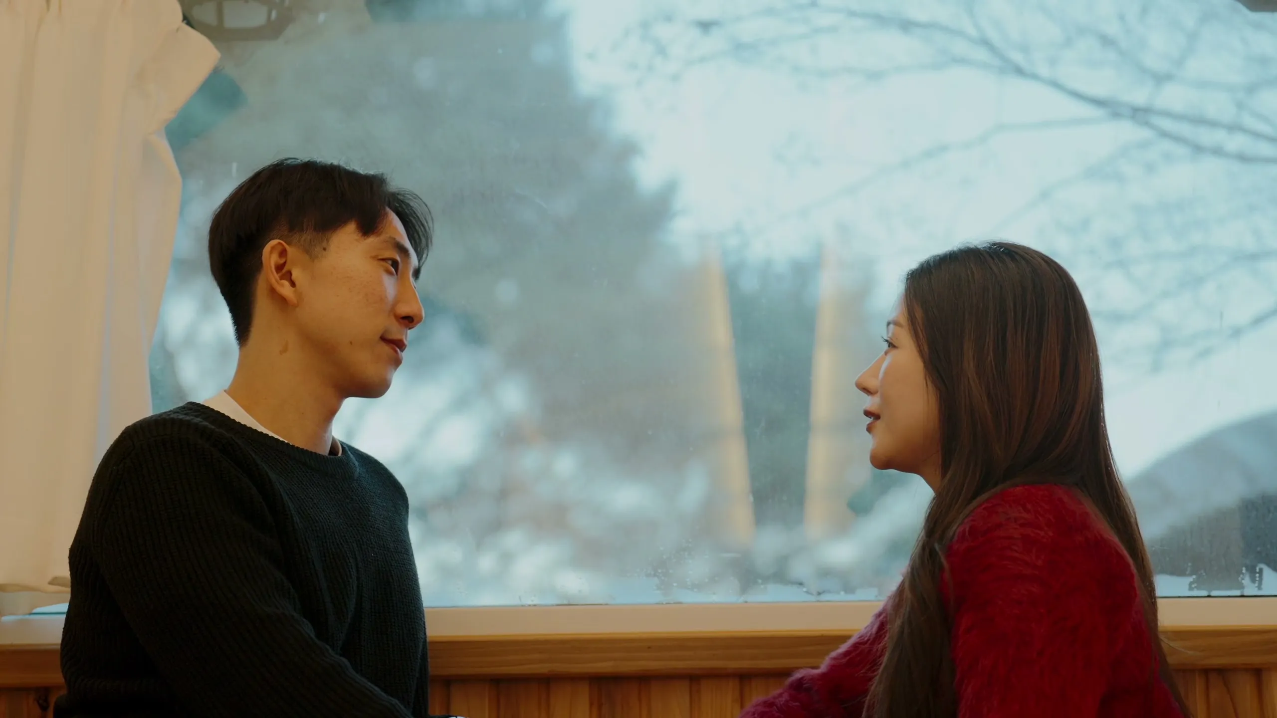 Inside the tent, the two of them turned to face each other by the curtained window.