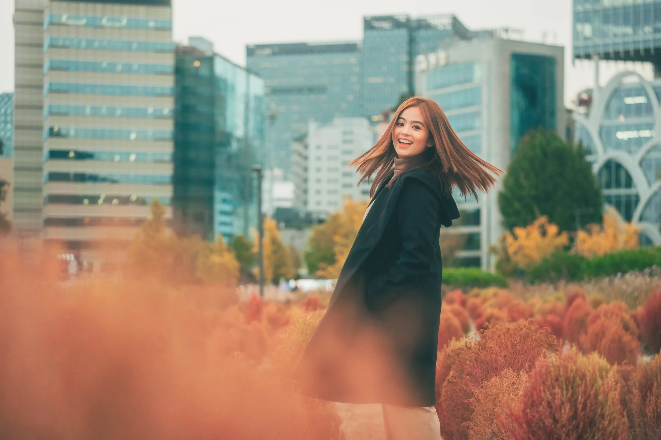 Bea among red autumn bushes in Seoul