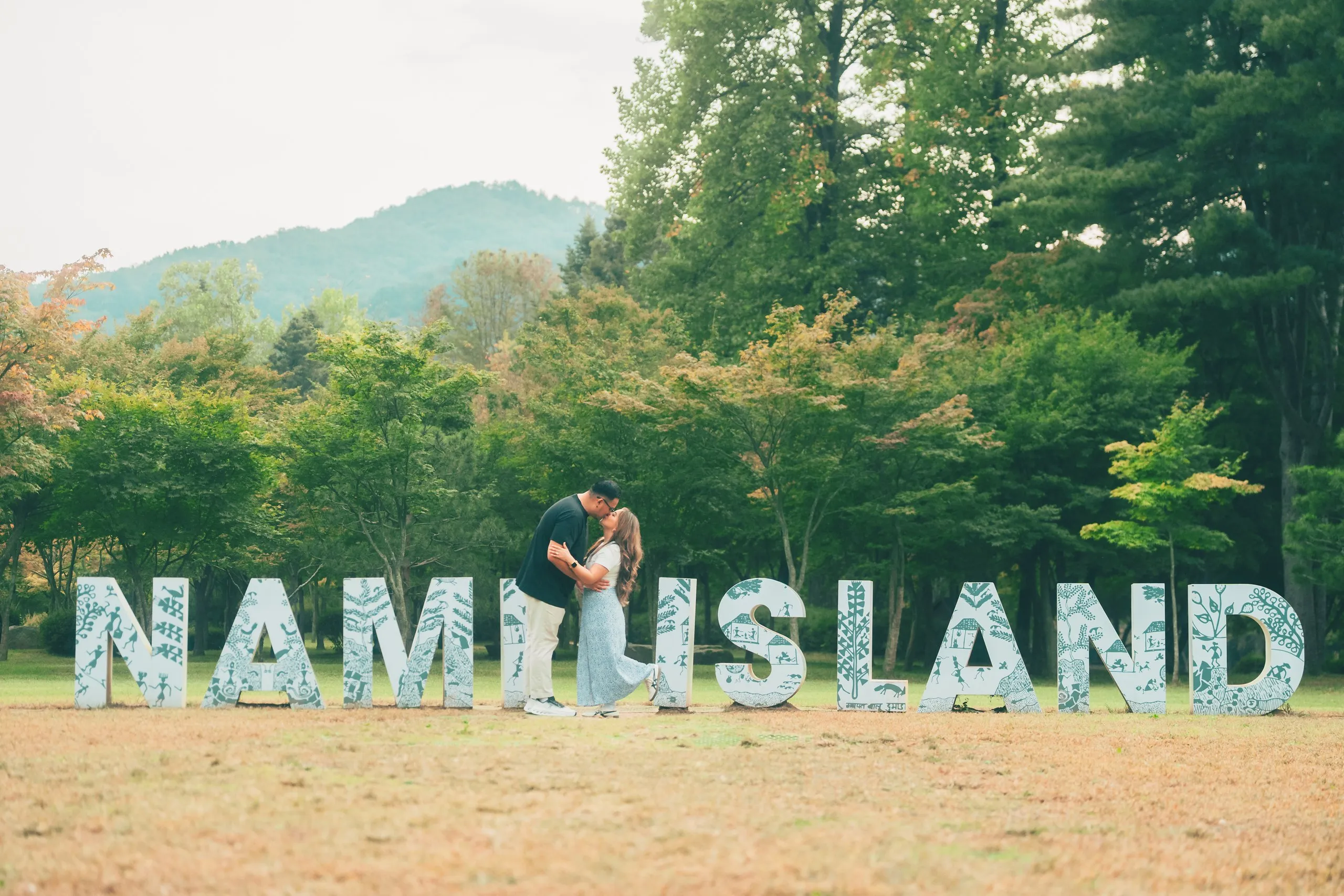 A kiss between the giant NAMI ISLAND letters.