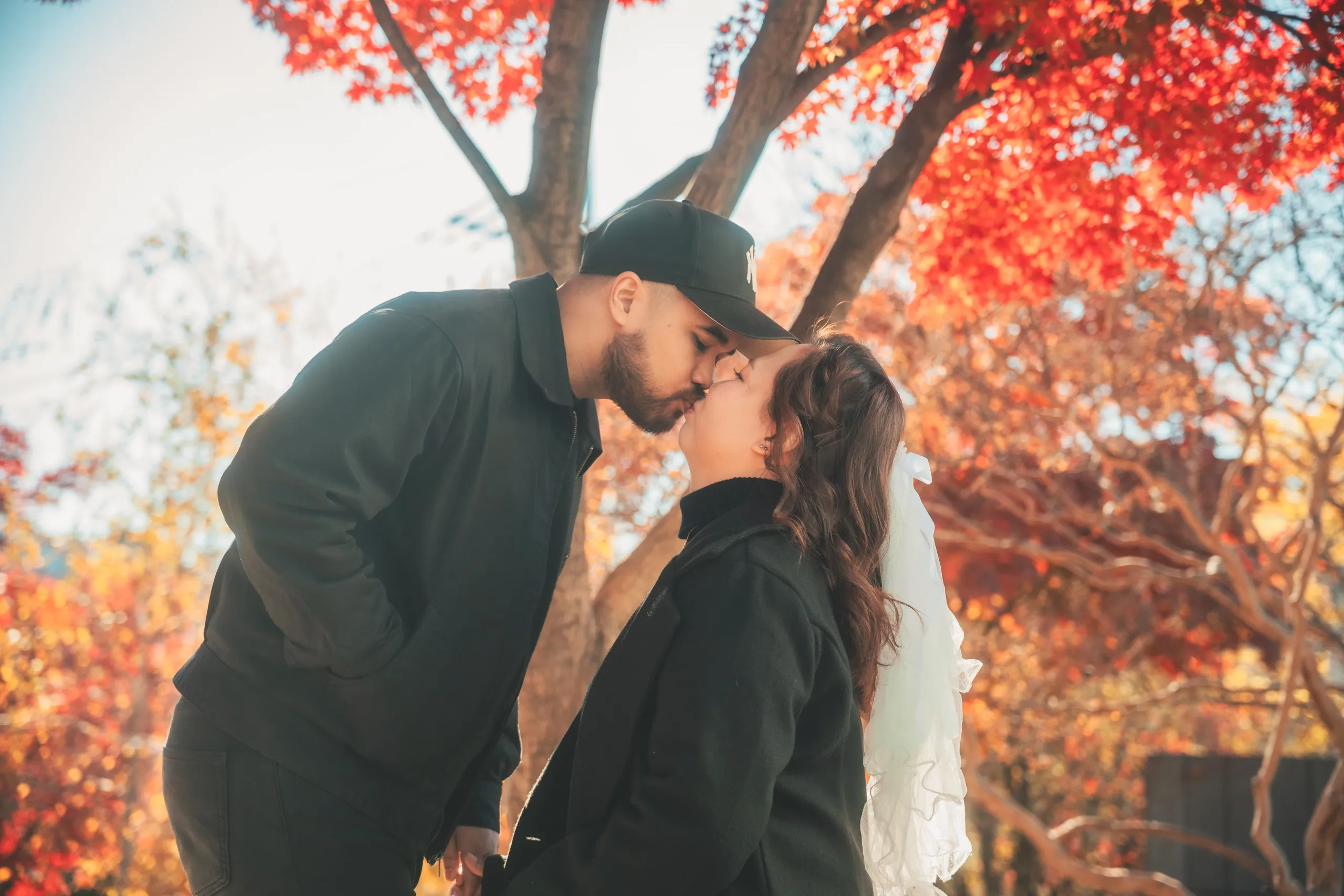A kiss under red maple leaves