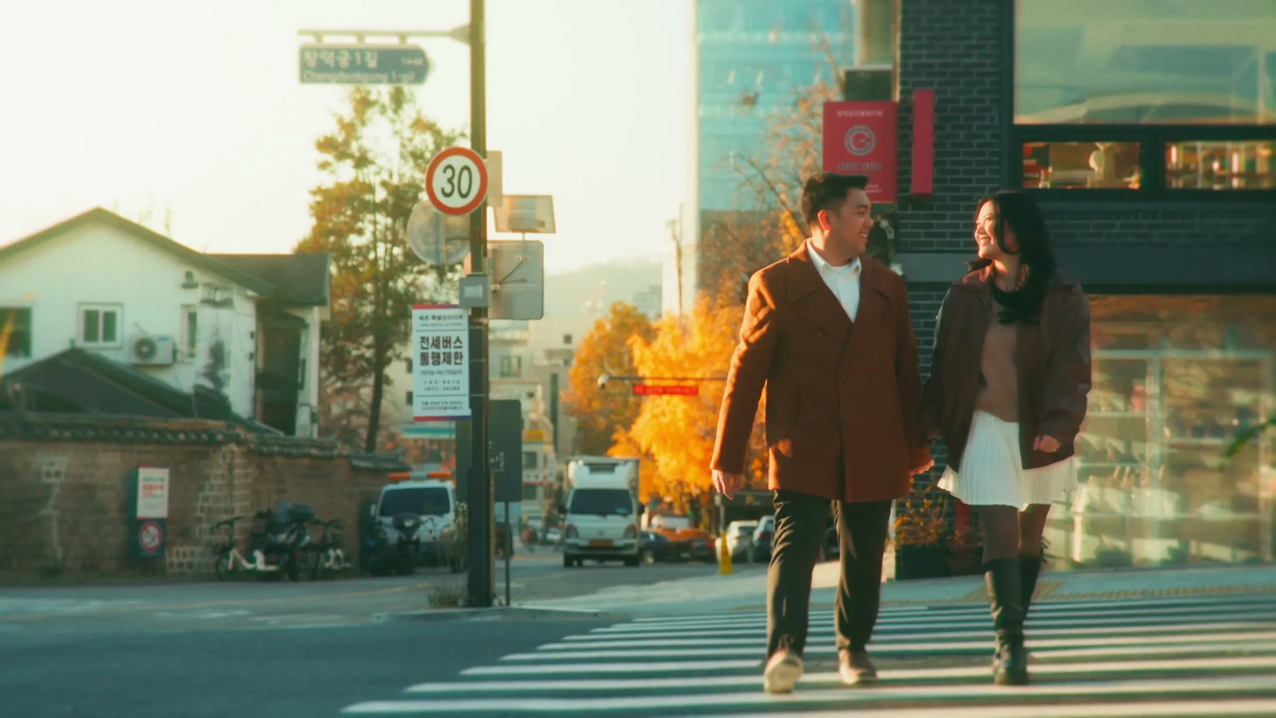 Marielle and her partner on an autumn street in Anguk-dong