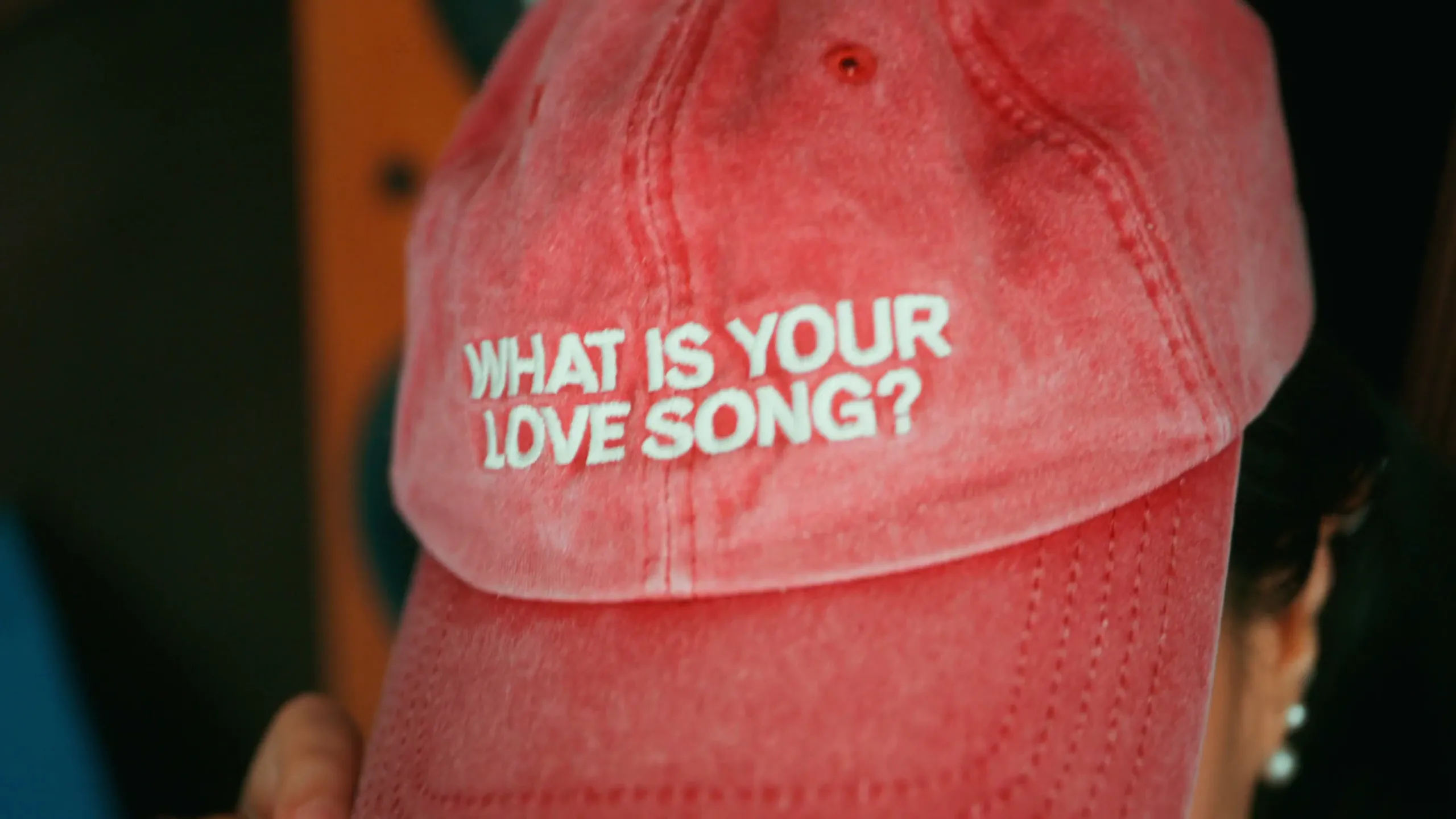 The red cap from the film, embroidered with the question