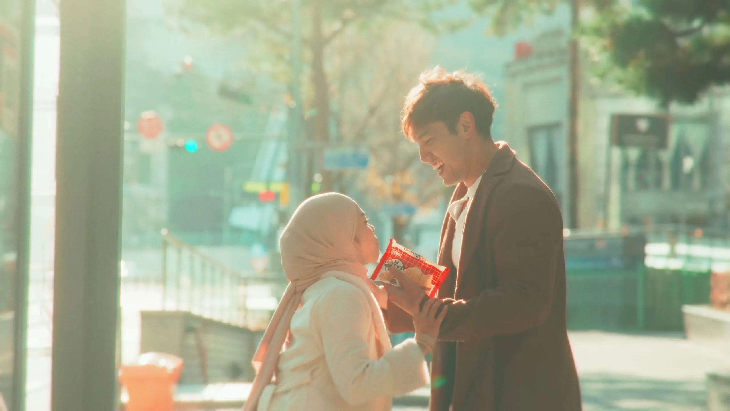 Blowing on a hot street snack together